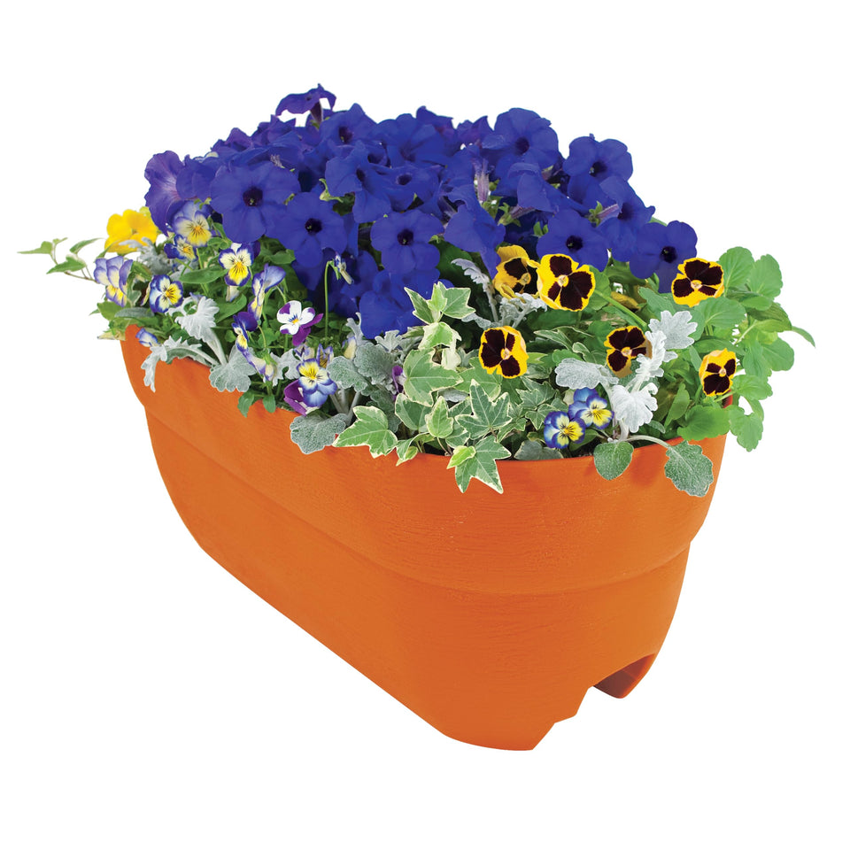 EMSCO Bloomers railing planter on balcony with terracotta finish, ideal for herbs and small vegetables.