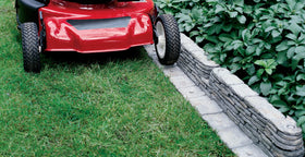 Emsco Group Bedrocks edging close-up showing durable stakes for no-dig installation.