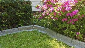 Emsco Group Bedrocks trim-free flange prevents grass encroachment along borders.