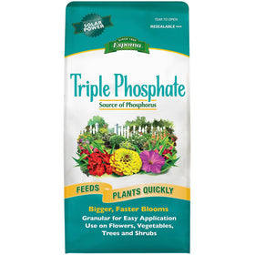 Espoma Triple Phosphate granules (0-45-0) boosting root growth and blooming in garden plants.