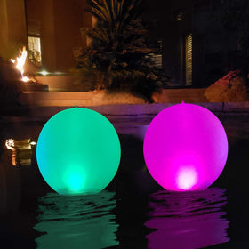 Esuper 14-inch inflatable pool light ball glowing in pool for ambiance.