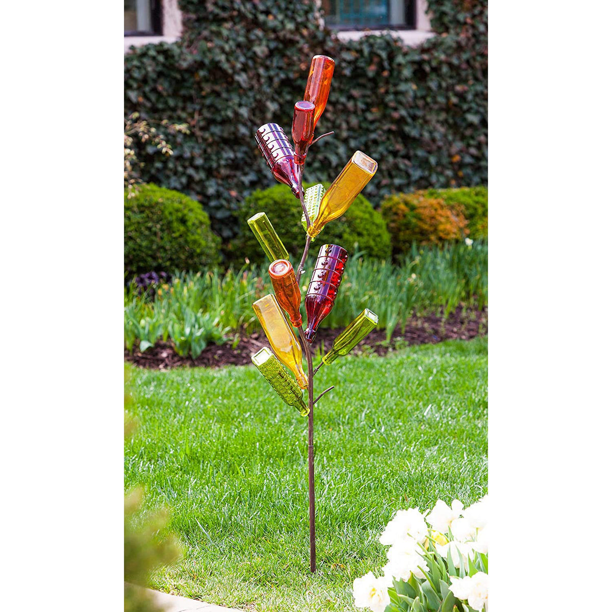 Evergreen Garden outdoor decor lets sunlight shine through colored bottles.