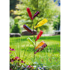 Evergreen Garden metal bottle tree stands outdoors, weather resistant for year-round yard decor.