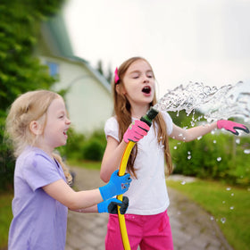 Evridwear Kids Gardening Gloves pink worn by a child during outdoor yard work.