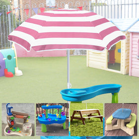 Exokugo pink umbrella at the beach provides sun protection for sand play
