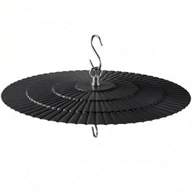 Eyrosa 11.5-inch rain guard over a bird feeder shields seeds from rain and sun.