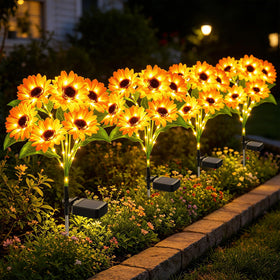 Falove solar sunflower lights with six heads illuminate garden paths at dusk.