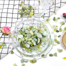 FANTIAN jade rocks in a glass hurricane offer decorative accent and moisture control.