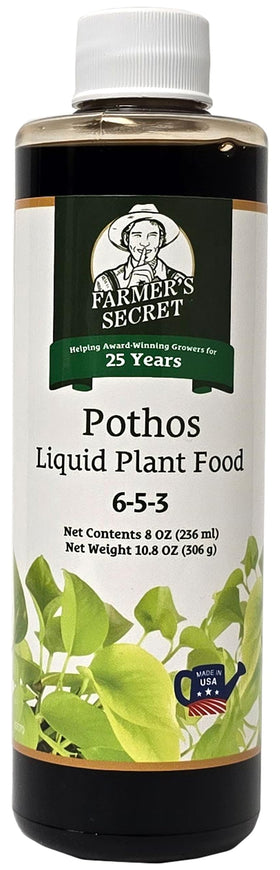 Farmer's Secret Pothos liquid plant food bottle beside a watering can, ready to nourish roots.