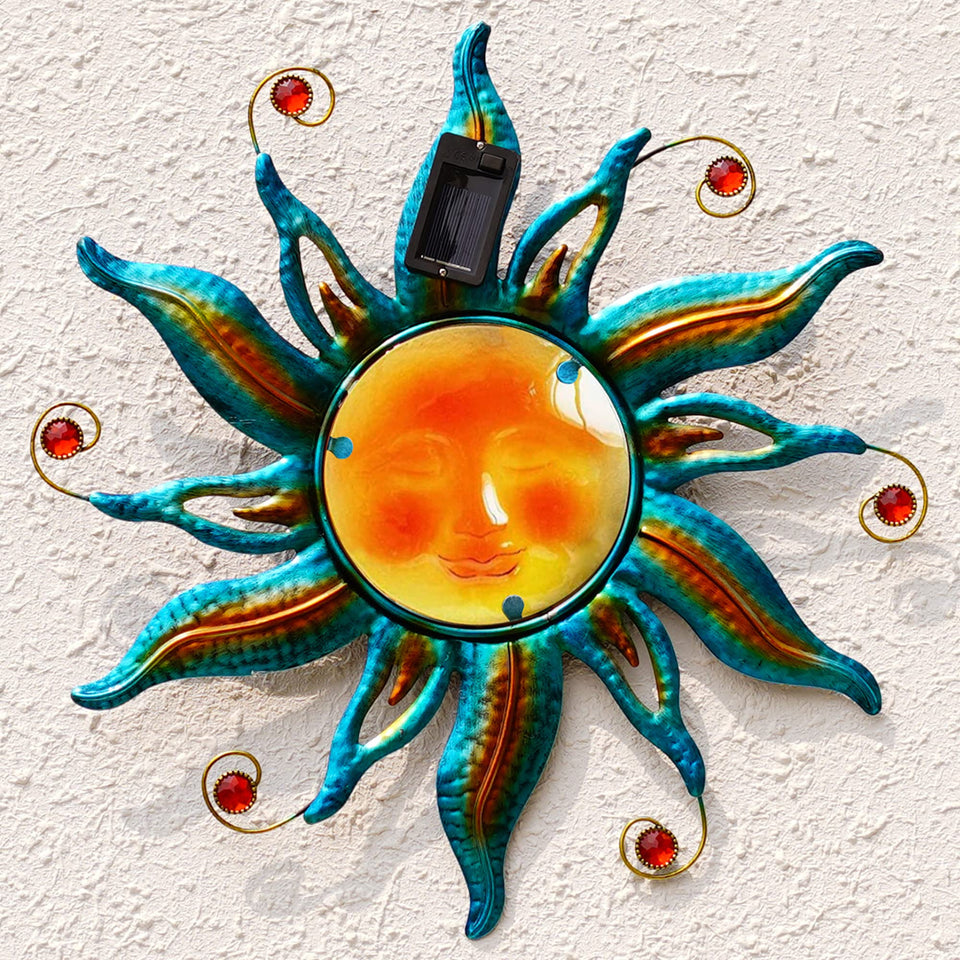 Fashionoda solar sun face wall art in blue, ideal garden focal point at dusk.
