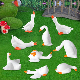 FCKLVMC mini goose figurine as a garden sculpture in a sunny corner