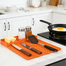 Find Law heat-resistant mat shields countertops near hot grates.