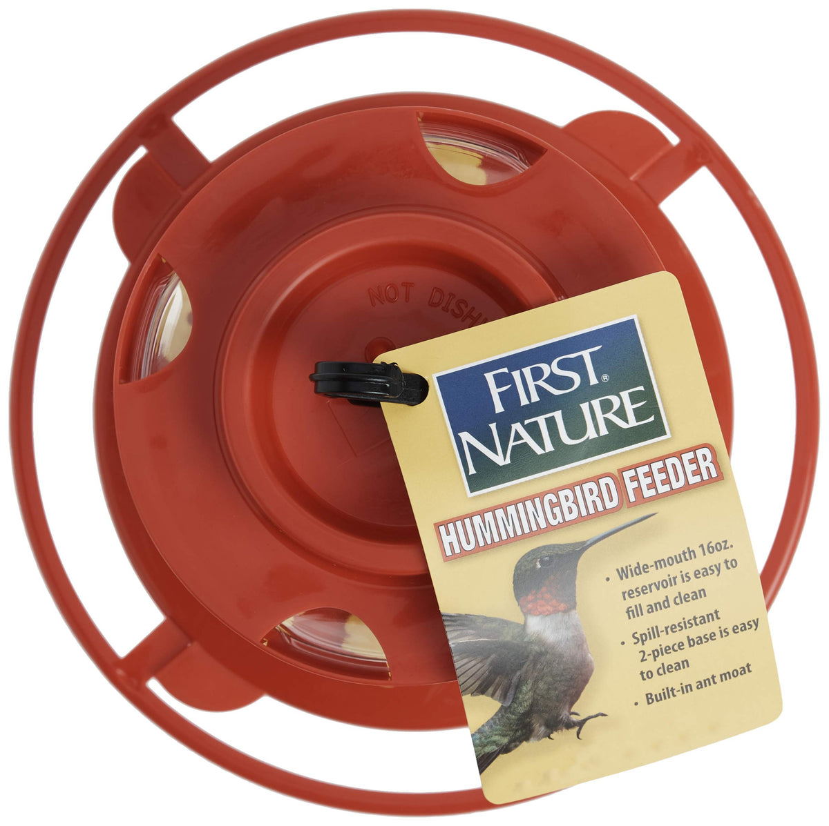 First Nature hummingbird feeder hanging from a hook or limb in outdoor setting.