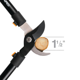 Fiskars lopper in garden setting showing powerful reach for tree trimming.