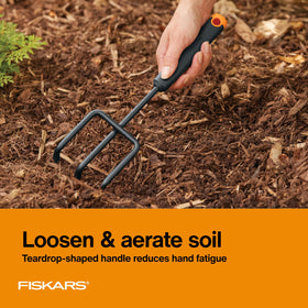 Fiskars transplanter with ergonomic handle reduces hand fatigue during transplanting.