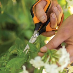 Fiskars Comfort Loop snips with sheath ready for garden use