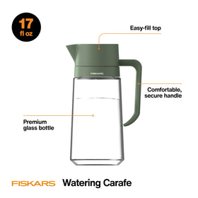 Fiskars Glass Watering Carafe with modern silhouette complements desk plants.