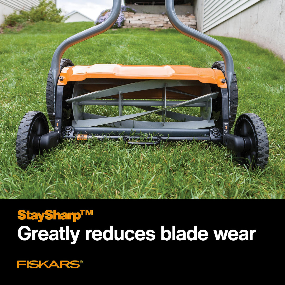 Fiskars StaySharp mower with reversible grass chute directing clippings away