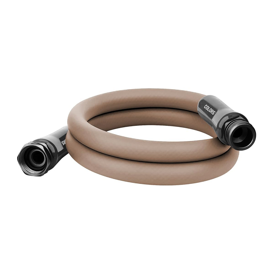 Flexzilla Colors garden hose with flat coil in brown mulch, kink-free and easy to maneuver.