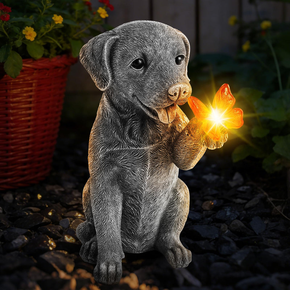 FloraSea solar dog statue glows in garden for ambient nighttime lighting.