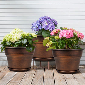 Fodetyff copper-tone planter with saucer keeps surfaces dry