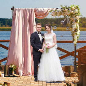 Fomcet wooden arch in a garden setting, rustic ceremony backdrop.