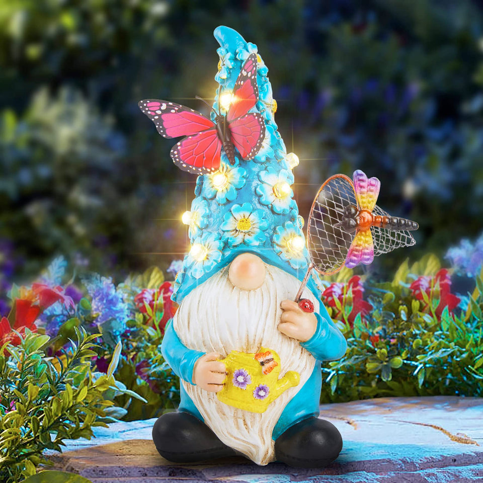 Foreby garden gnome with butterfly on LED flowers lighting up outdoor space.