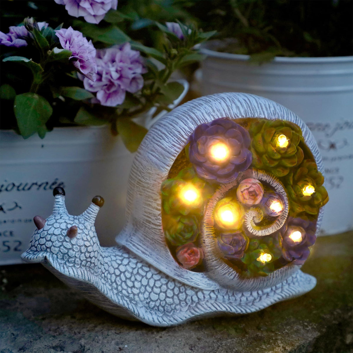 FORUP Snail Garden Statue close-up showing solar LED lighting for warm night illumination