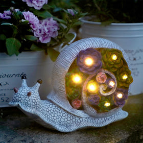 FORUP Snail Garden Statue close-up showing solar LED lighting for warm night illumination