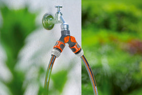 Gardena Y-valve connected to hoses enables two watering tasks.