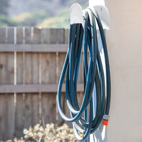 Gardzen hose rack organized outdoors for easy access and neat storage