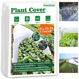 Garutom frost cover 10x33 setup over a garden bed shields vegetables.