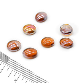 Close-up of GasSaf Amber Luster glass drops showing jewel-like color