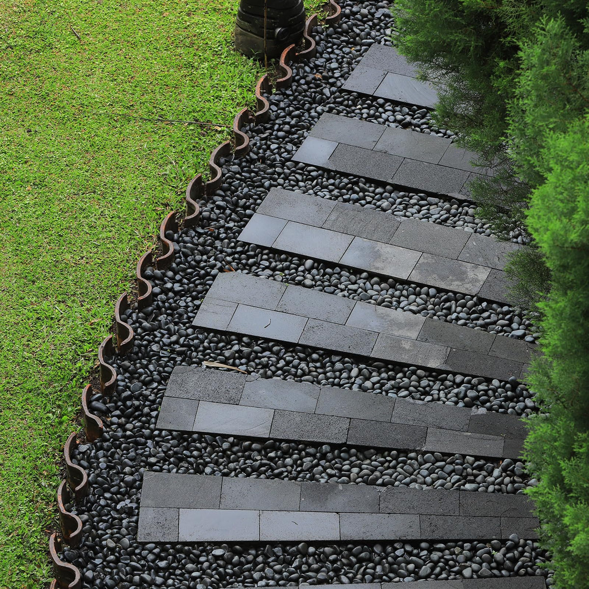 GASPRO river stones in a garden display delivering color contrast and moisture-friendly ambiance.