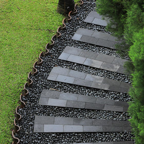 GASPRO river stones in a garden display delivering color contrast and moisture-friendly ambiance.