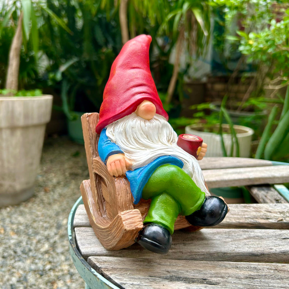 Generic drinking coffee gnome statue holding a cup, ideal for outdoor spaces.