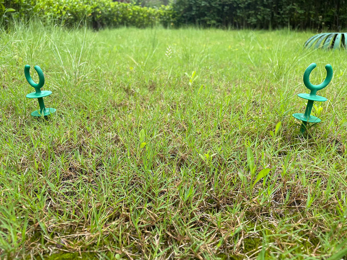 Generic garden hose nails close-up, shows sturdy plastic design for outdoor use.