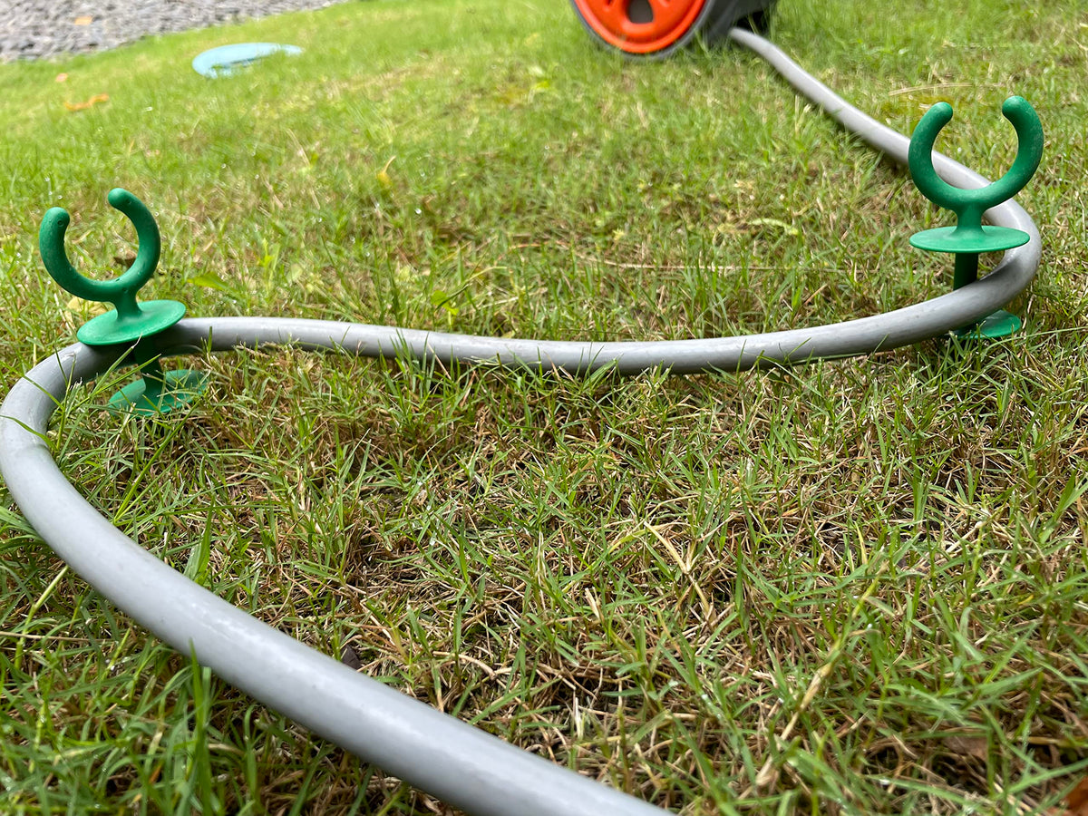Generic garden hose guide for outdoor use, keeps watering area organized.
