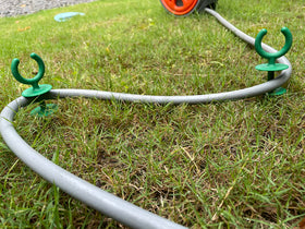 Generic garden hose guide for outdoor use, keeps watering area organized.