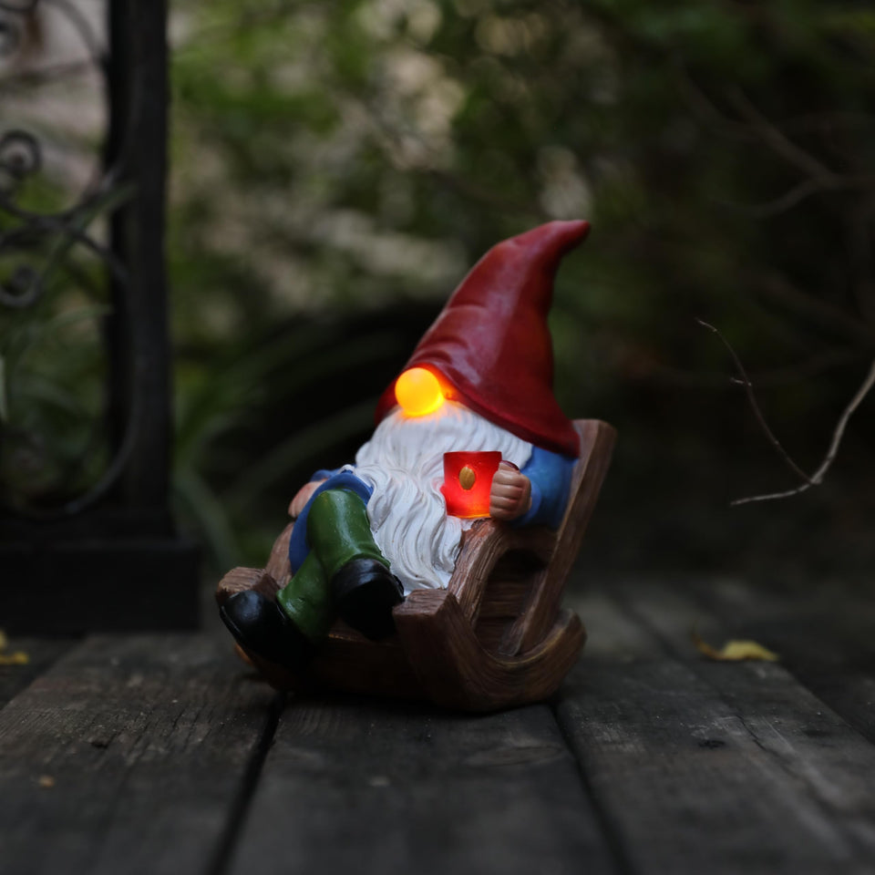 Generic solar garden gnome chair light glowing at dusk for outdoor charm