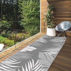 GENIMO RV camping rug folds compactly, fits carry bag with stakes for stable placement.