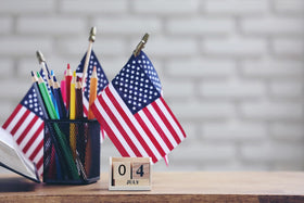 GiftExpress handheld US flags on sturdy wooden sticks for events.