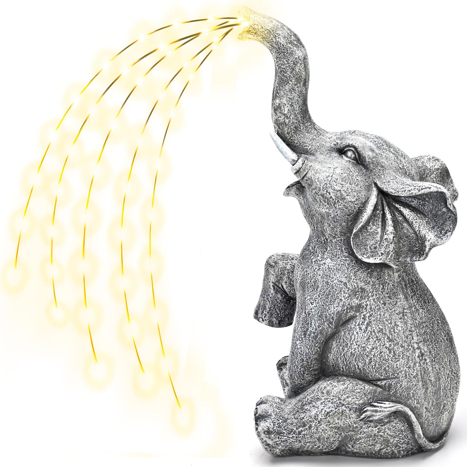GIGALUMI solar elephant statue with water-flow lights brightening garden paths at night.
