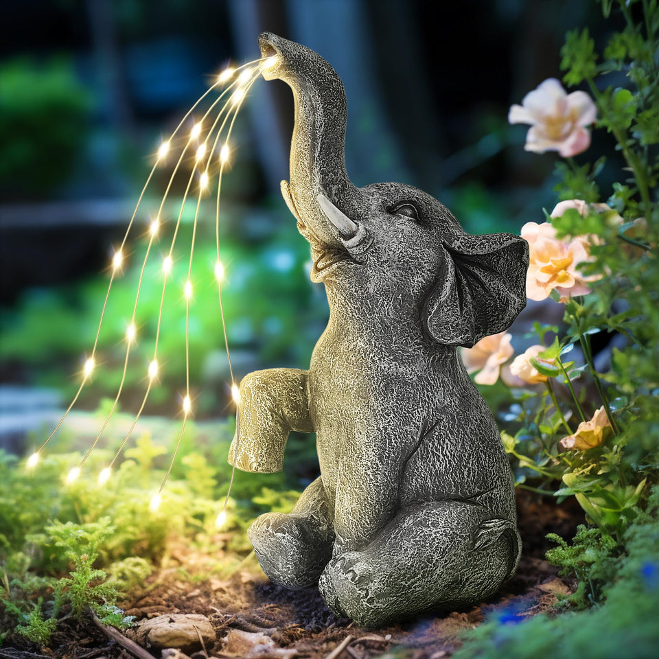 GIGALUMI watering elephant statue, front view, glowing water-like flow enhances outdoor garden ambiance.