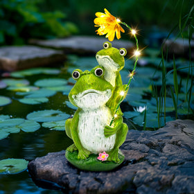 GIGALUMI frog sculpture harmonizes with garden lights, enhancing twilight ambiance.