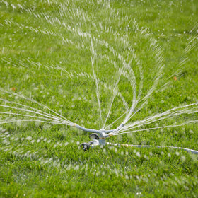 Gilmour rotary sprinkler head with wide 360-degree rotation across the lawn