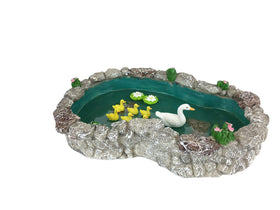 GlitZGlam duck pond scene pairs with lily pads for a peaceful garden ambiance