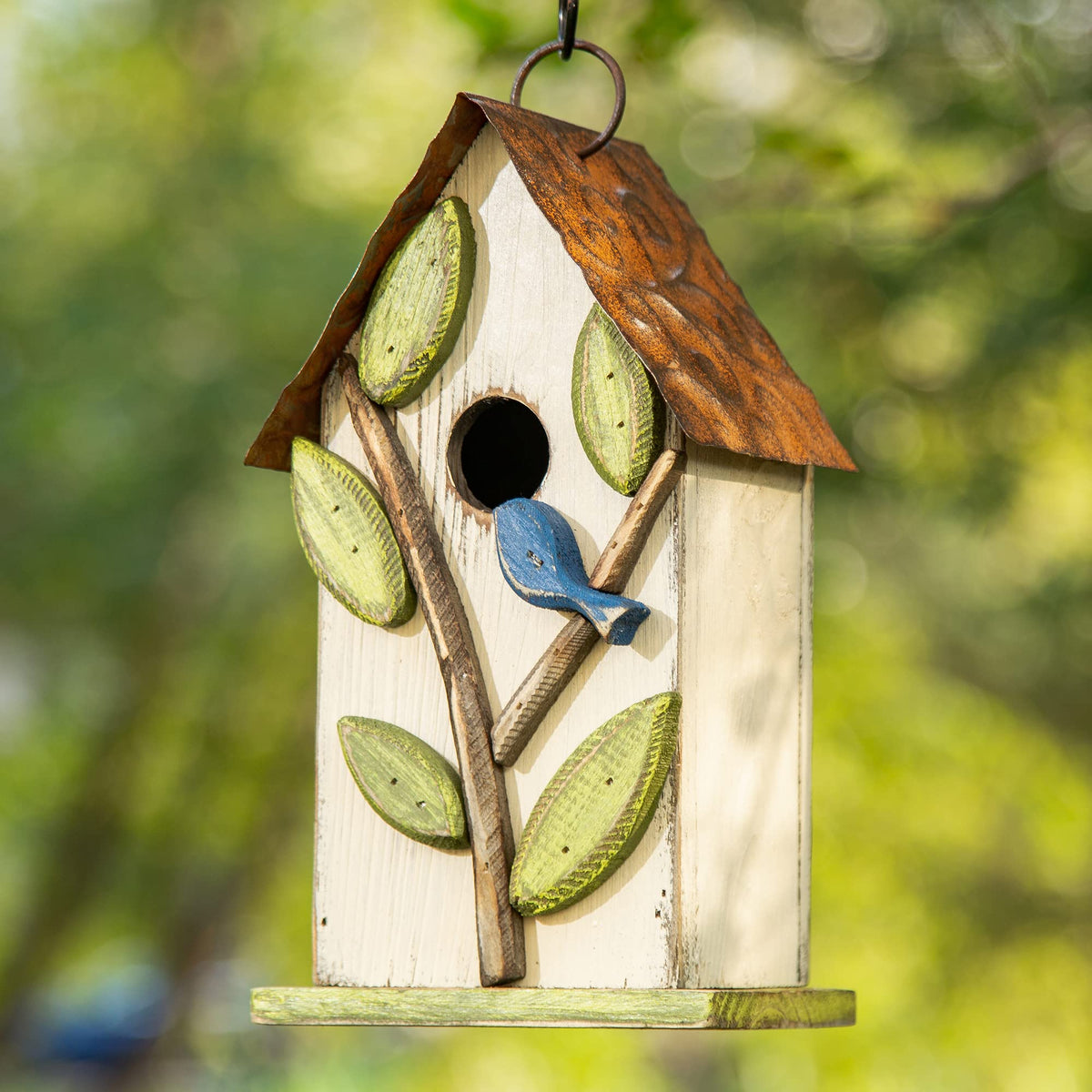 Glitzhome distressed white birdhouse with leaf motif enhances garden ambience.