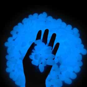 GLOCARNIVAL Glow Pebbles illuminate a garden walkway with blue glow at night