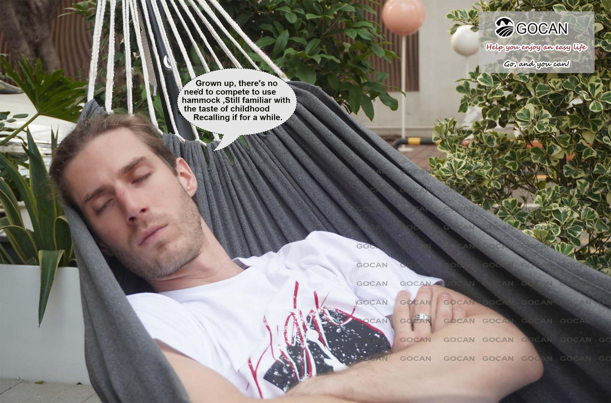 Two-person lounging on a GOCAN hammock, ideal for balcony or patio.